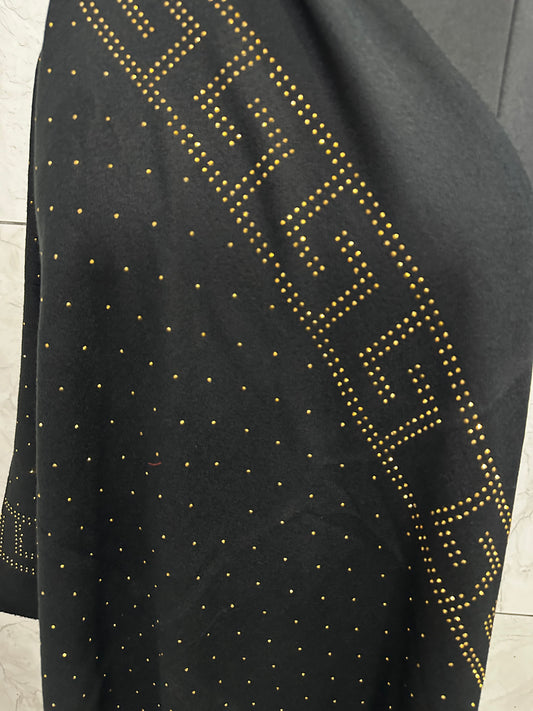 This black shawl has a much more sophisticated, "night out" energy compared to the first one. The gold studding in that Greek-key style border gives it a high-end, Versace-inspired look.