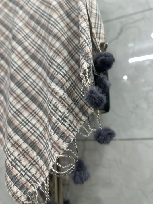 This piece has a completely different vibe—much more cozy, rustic, and playful with those pom-poms. The checkered pattern gives it a timeless, "cottagecore" aesthetic.