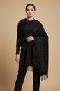 This black shawl has a much more sophisticated, "night out" energy compared to the first one. The gold studding in that Greek-key style border gives it a high-end, Versace-inspired look.