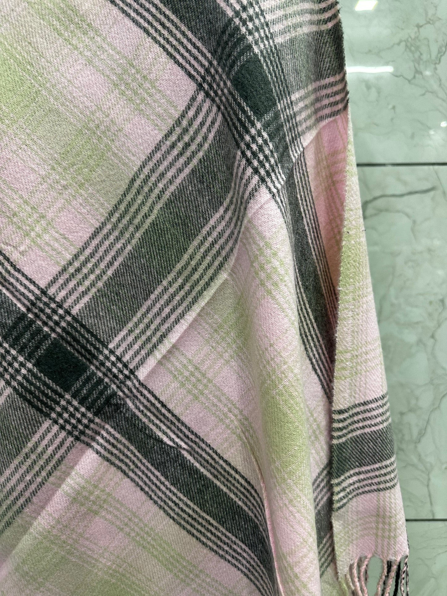 he mix of soft pastel pink with those structured grey and tan checks gives it a perfect balance of "cozy" and "sophisticated."